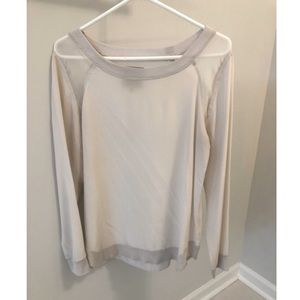 White blouse with sheer sleeves.